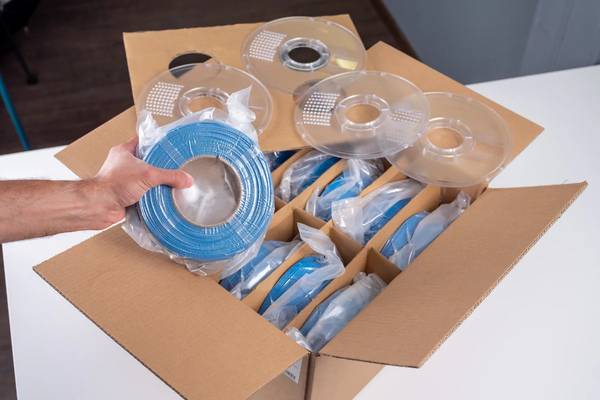 Enter B2B 8 Box of AzureFilm filament refills packed with blue filament