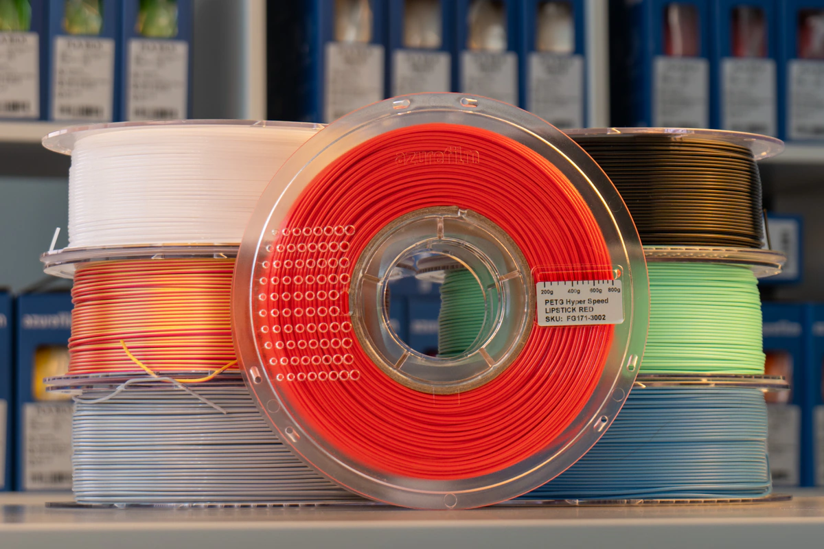 Bambu Lab H2C Combo 8 AzureFilm filament refill on a transparent Master Spool